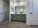 Bathroom featuring double sinks, gray cabinets, and tile floors at 22852 E Lords Way, Queen Creek, AZ 85142