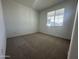 Neutral bedroom featuring carpeted floors, a window, and light-colored walls at 22852 E Lords Way, Queen Creek, AZ 85142