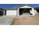 Single Gathering home showcasing a two-car garage, covered entryway, and gray exterior at 22852 E Lords Way, Queen Creek, AZ 85142