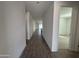 Hallway with wood-look flooring, neutral walls and access to rooms in a modern, well-lit home at 22852 E Lords Way, Queen Creek, AZ 85142