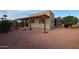 Backyard features a pergola, gravel landscaping, and a citrus tree at 25417 S Kansas Ave, Sun Lakes, AZ 85248