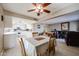 Bright dining area with wood table and chairs near kitchen and living room at 25417 S Kansas Ave, Sun Lakes, AZ 85248