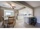 Dining area with wood chairs and table, open to kitchen at 25417 S Kansas Ave, Sun Lakes, AZ 85248