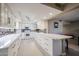 Modern kitchen with white cabinets, quartz countertops, and glass-front cabinets at 25417 S Kansas Ave, Sun Lakes, AZ 85248