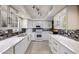 Modern kitchen with white cabinets, quartz countertops, and tile backsplash at 25417 S Kansas Ave, Sun Lakes, AZ 85248