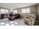 Living room with leather sofas, recliner, and coffee table at 25417 S Kansas Ave, Sun Lakes, AZ 85248