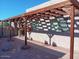 Wooden pergola with hanging flower baskets along a walkway at 25417 S Kansas Ave, Sun Lakes, AZ 85248