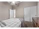 Serene bedroom with a gray and white bedding set and closet at 25583 W Beth Dr, Buckeye, AZ 85326