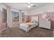 Charming bedroom with a single bed, pink walls, and plenty of natural light at 25583 W Beth Dr, Buckeye, AZ 85326