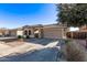 Tan house with tile roof, two-car garage, and desert landscaping at 25583 W Beth Dr, Buckeye, AZ 85326