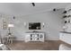 Living room with TV, media console, and built-in shelving at 25583 W Beth Dr, Buckeye, AZ 85326