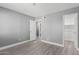 Gray-walled bedroom with mirrored closet and window at 2847 N 46Th Ave # 8, Phoenix, AZ 85035