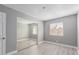 Well-lit bedroom with mirrored closet doors and gray walls at 2847 N 46Th Ave # 8, Phoenix, AZ 85035