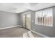 Bright bedroom with sliding glass door and gray walls at 2847 N 46Th Ave # 8, Phoenix, AZ 85035