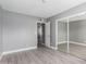 Bright bedroom with mirrored closet doors and wood-look floors at 2847 N 46Th Ave # 8, Phoenix, AZ 85035