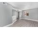 Living area with grey walls, wood-look floors, and a view of a door at 2847 N 46Th Ave # 8, Phoenix, AZ 85035