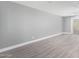 Spacious living room with grey walls and wood-look floors at 2847 N 46Th Ave # 8, Phoenix, AZ 85035