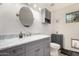 Clean bathroom with gray vanity, marble countertop, and oval mirror at 3034 N Ricardo --, Mesa, AZ 85215