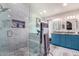 Modern bathroom with blue vanity, marble shower, and dual sinks at 3034 N Ricardo --, Mesa, AZ 85215