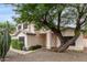 Two-story house with desert landscaping and a large tree near the entrance at 3034 N Ricardo --, Mesa, AZ 85215