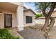 Front entrance with decorative, dark-brown door and a sidelight window at 3034 N Ricardo --, Mesa, AZ 85215