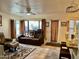 Relaxing living room featuring a brown leather sectional sofa and a ceiling fan at 3034 N Ricardo --, Mesa, AZ 85215