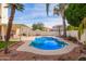 Inviting backyard oasis featuring a sparkling pool, patio, and lush landscaping at 3124 N Sage Cir, Avondale, AZ 85392