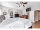 Main bedroom with a ceiling fan, large TV and walk-in closet at 3124 N Sage Cir, Avondale, AZ 85392