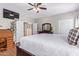 Main bedroom with ceiling fan, large TV, and walk-in closet at 3124 N Sage Cir, Avondale, AZ 85392