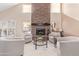 Living room features a large stone fireplace, hardwood floors, and lots of natural light at 3124 N Sage Cir, Avondale, AZ 85392