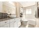 Clean bathroom with white cabinets, granite countertop, and bathtub at 3213 N 41St Pl, Phoenix, AZ 85018