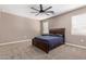 Comfortable bedroom with a ceiling fan and carpeted floor at 3317 N 300Th Dr, Buckeye, AZ 85396