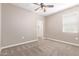 Bright bedroom with ceiling fan and neutral walls at 3317 N 300Th Dr, Buckeye, AZ 85396