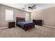 Well-lit bedroom with carpeted floor and ceiling fan at 3317 N 300Th Dr, Buckeye, AZ 85396