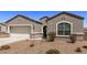 Gray house with a two-car garage and front yard landscaping at 3317 N 300Th Dr, Buckeye, AZ 85396