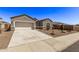 Single story home with a two-car garage and desert landscaping at 3317 N 300Th Dr, Buckeye, AZ 85396