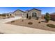 Two-car garage, gray stucco exterior, and a well-maintained front yard at 3317 N 300Th Dr, Buckeye, AZ 85396