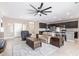 Open living room features a ceiling fan and views of the kitchen at 3317 N 300Th Dr, Buckeye, AZ 85396