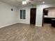 Bright living room with wood-look tile floors and kitchen view at 3480 E Sheffield Rd, Gilbert, AZ 85296