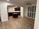 Open living area with wood-look floors and kitchen view at 3480 E Sheffield Rd, Gilbert, AZ 85296