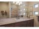 Bathroom with single sink vanity, shower, and tiled walls at 36050 N Summit Dr, Cave Creek, AZ 85331