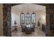 Elegant dining room with arched windows and a chandelier at 36050 N Summit Dr, Cave Creek, AZ 85331