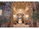 Grand entryway with stone arch, wrought iron doors, and lighting at 36050 N Summit Dr, Cave Creek, AZ 85331