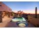 Resort style pool and spa with fire pit and sunset views at 36050 N Summit Dr, Cave Creek, AZ 85331