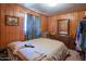 Bedroom with dresser, full bed, and wood paneling at 3616 S 67Th Ave, Phoenix, AZ 85043