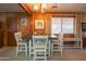 Dining area features a wood table and white chairs at 3616 S 67Th Ave, Phoenix, AZ 85043