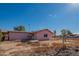 Back view of a pink home with a large yard at 3616 S 67Th Ave, Phoenix, AZ 85043