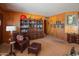 Living room with leather chair and built-in bookcase at 3616 S 67Th Ave, Phoenix, AZ 85043