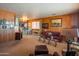 Living room features leather furniture and wood paneling at 3616 S 67Th Ave, Phoenix, AZ 85043