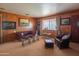 Spacious living room with leather furniture and wood paneling at 3616 S 67Th Ave, Phoenix, AZ 85043